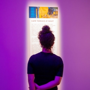 TLM-woman-in-front-of-panel-Interpretive-Area-1024×596